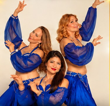 Three Hazz Dance Studio belly dancers in royal blue costumes